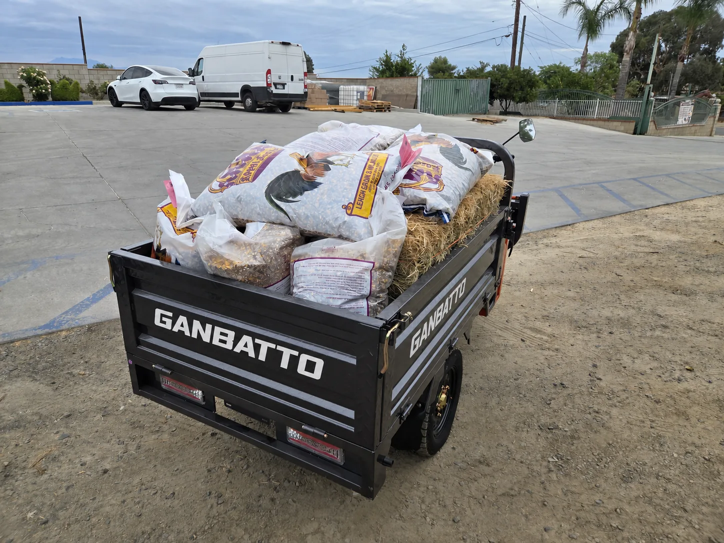 Rear view of a Ganbatto cargo bed loaded with hay and feed bags