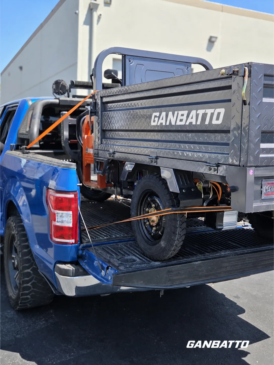 Ganbatto cargo tricycle secured in a pickup bed for delivery